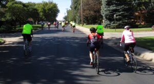 Bike riders from the 2019 Falun Classic ride, heading west on Swensson St.